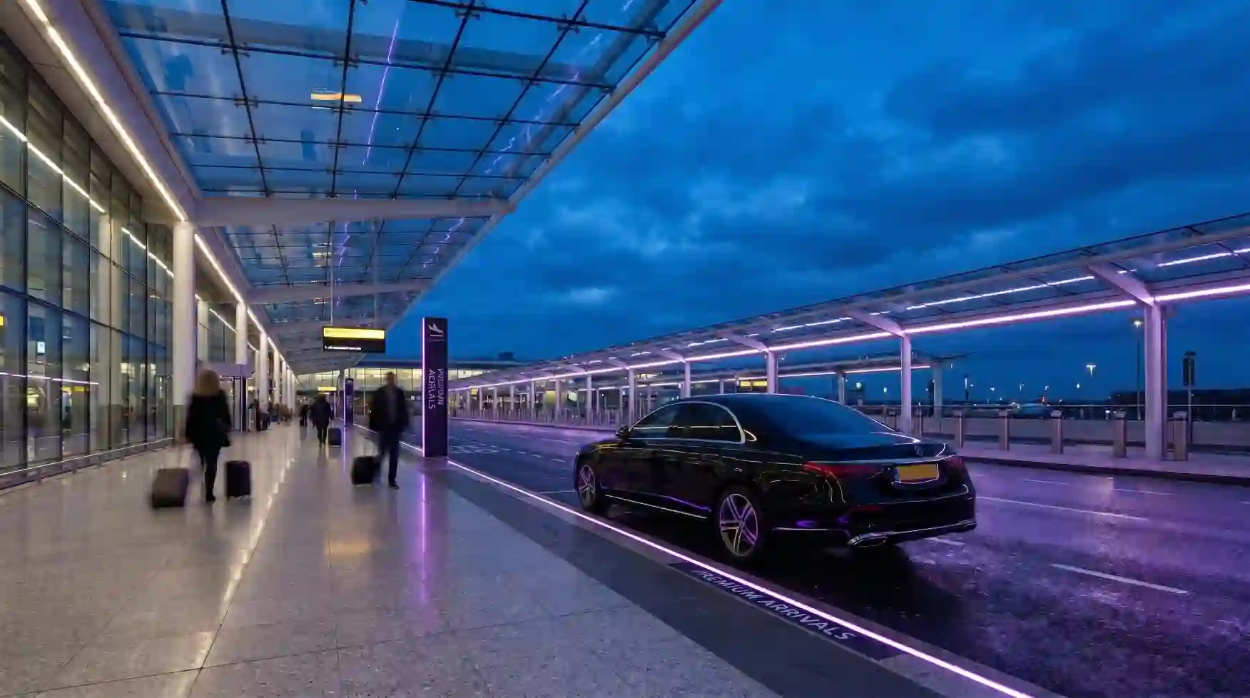 Manchester Airport Terminal 2 premium arrivals kerb at twilight with executive chauffeur vehicle