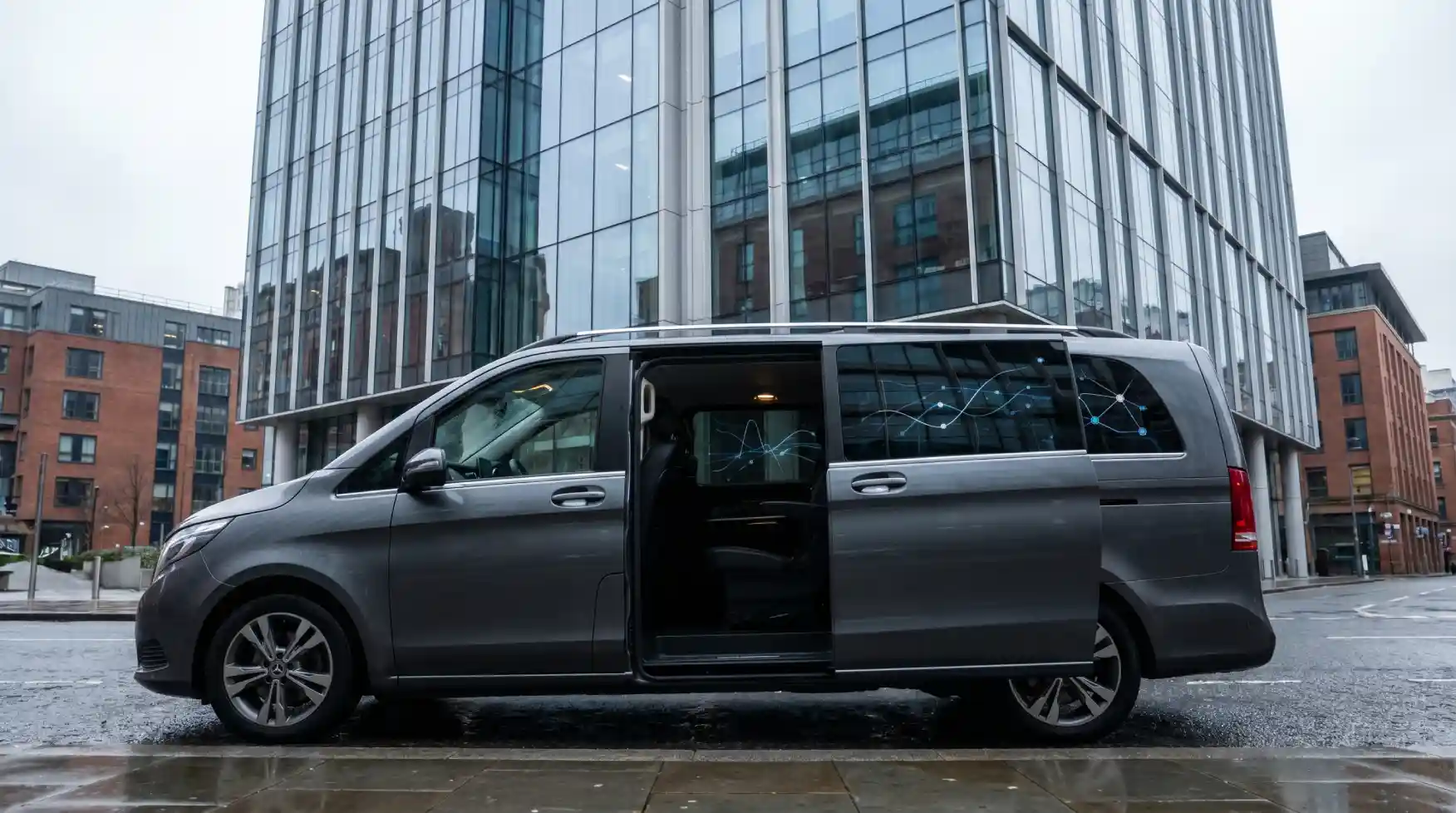 Executive chauffeur MPV outside modern glass office tower for corporate travel and duty of care